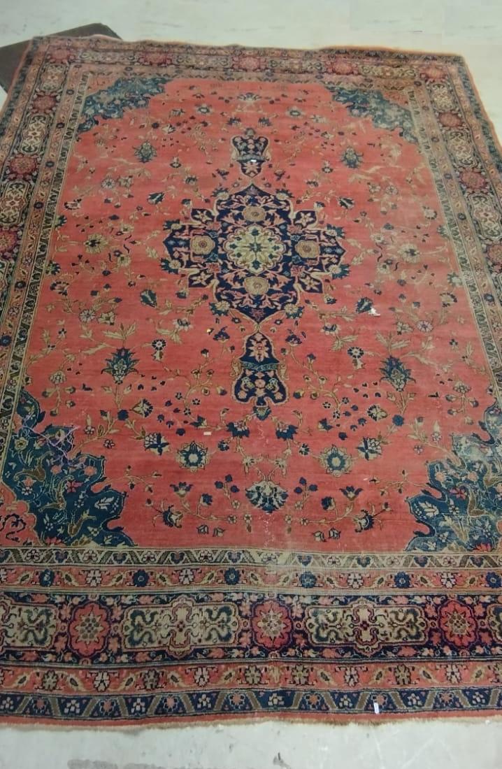 A PERSIAN CARPET, 20th century, the dusky pink field with scattered flowerheads, navy blue central Image