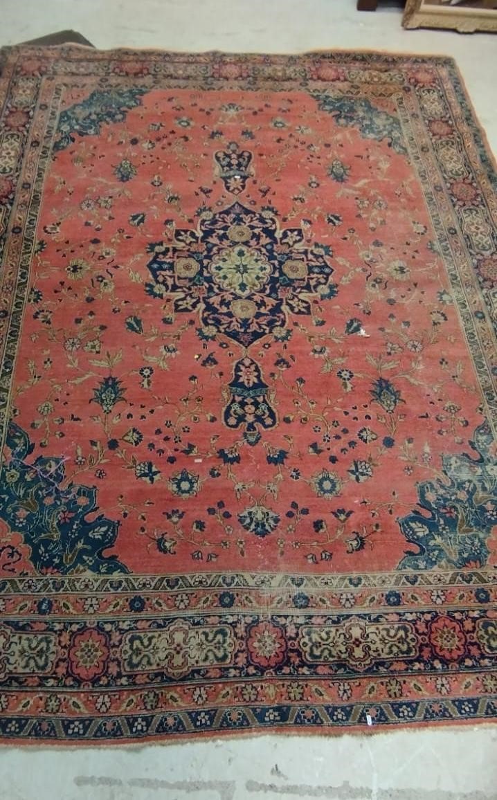 A PERSIAN CARPET, 20th century, the dusky pink field with scattered flowerheads, navy blue central Image