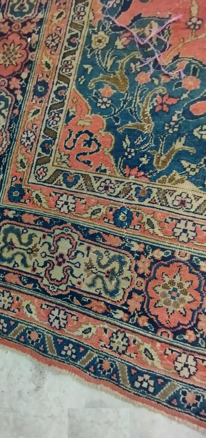 A PERSIAN CARPET, 20th century, the dusky pink field with scattered flowerheads, navy blue central Image