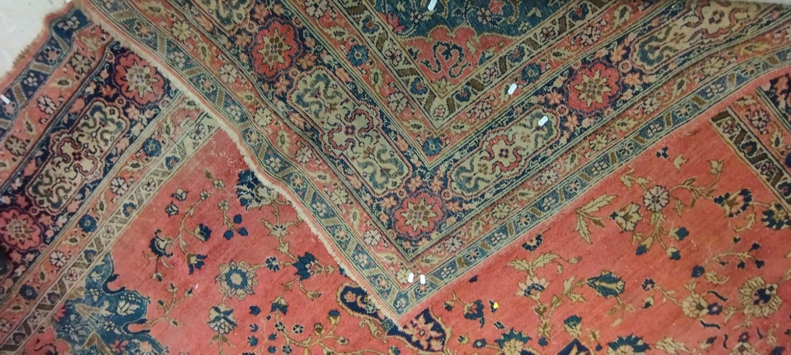 A PERSIAN CARPET, 20th century, the dusky pink field with scattered flowerheads, navy blue central Image
