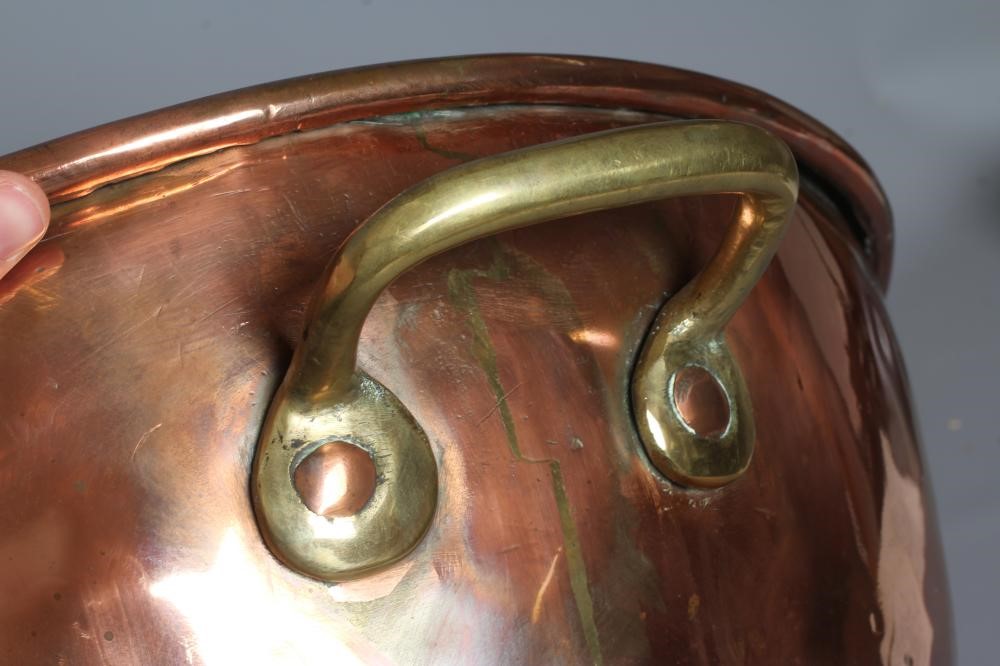 A VICTORIAN COPPER AND BRASS BASIN of two handled deep circular form, 9 3/4" high, 21 3/4" diameter Image