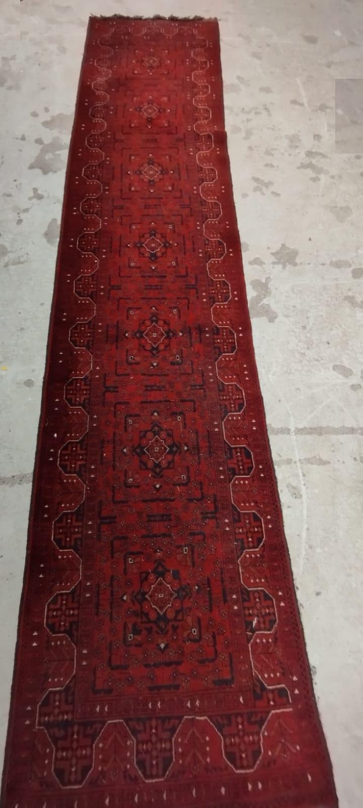 A PERSIAN STYLE RUNNER, second half 20th century, the red field with seven linked guls in navy and Image