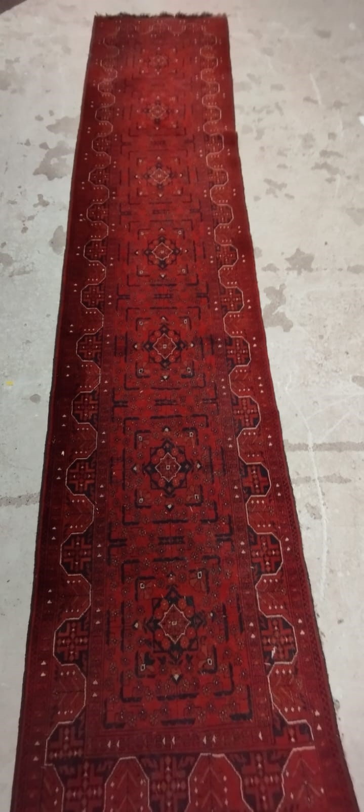 A PERSIAN STYLE RUNNER, second half 20th century, the red field with seven linked guls in navy and Image