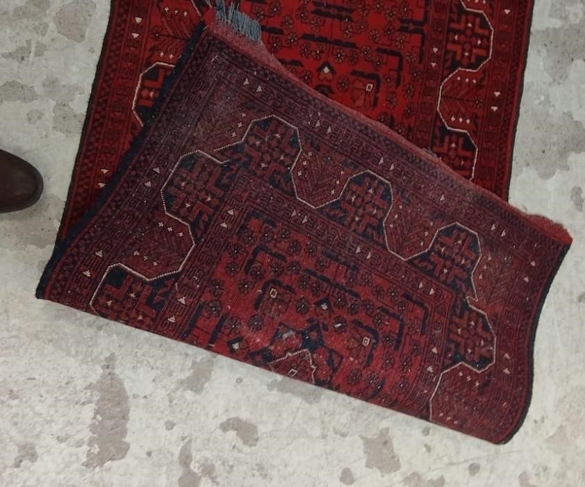 A PERSIAN STYLE RUNNER, second half 20th century, the red field with seven linked guls in navy and Image