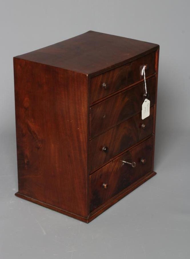 A MAHOGANY MINIATURE DOUBLE SIDED CHEST Image
