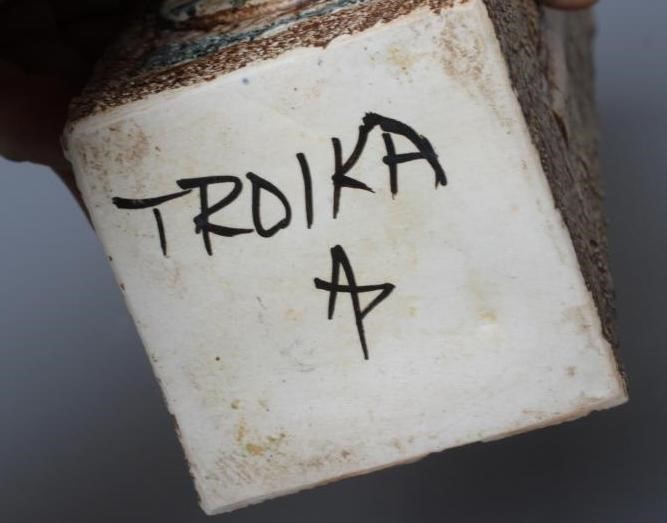 A TROIKA VASE by Avril Bennett, of plain square section, decorated in shades of brown and blue with Image