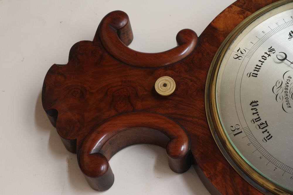 A VICTORIAN WALNUT WHEEL BAROMETER Image