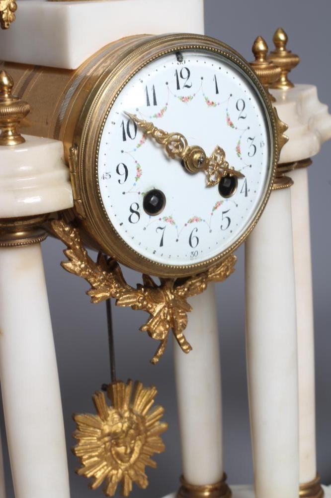 A FRENCH WHITE ONYX AND GILT METAL CLOCK GARNITURE Image