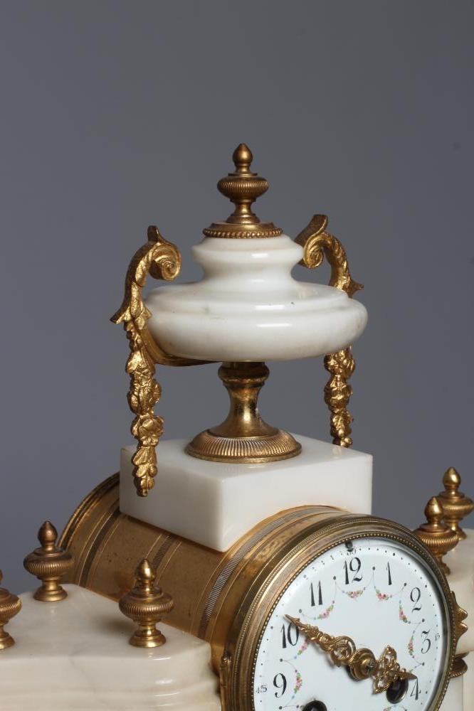 A FRENCH WHITE ONYX AND GILT METAL CLOCK GARNITURE Image