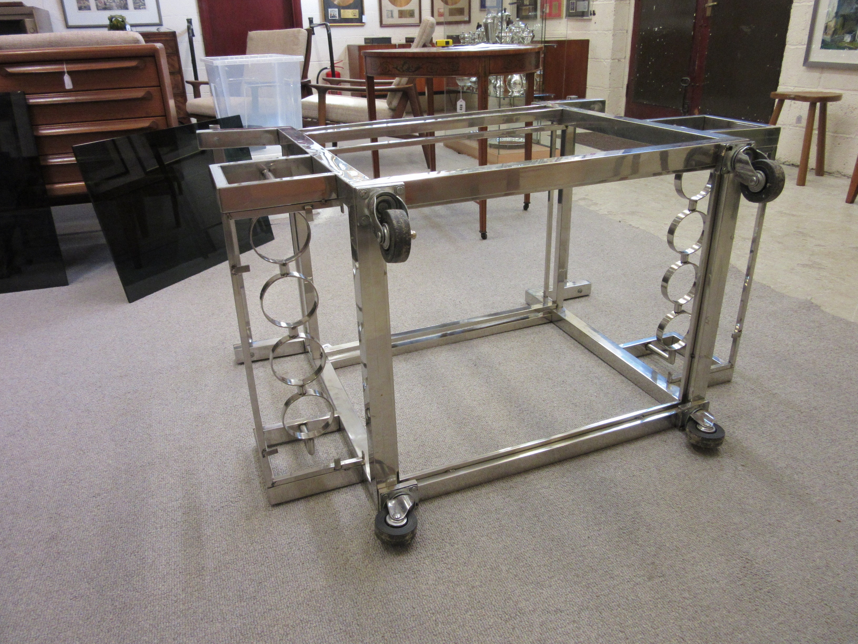 AN ART DECO CHROME FRAMED TWO TIER DRINKS TROLLEY of oblong form with black glass shelves Image
