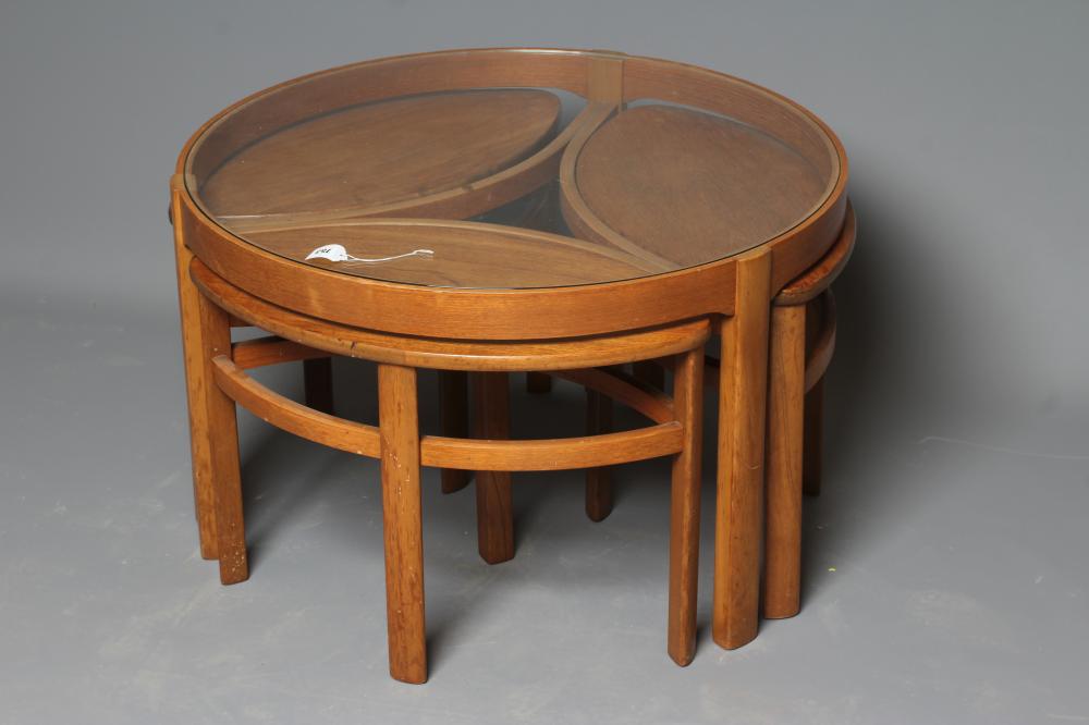A NATHAN TRINITY TEAK NEST OF FOUR TABLES, mid 20th century, the larger circular table with glass Image