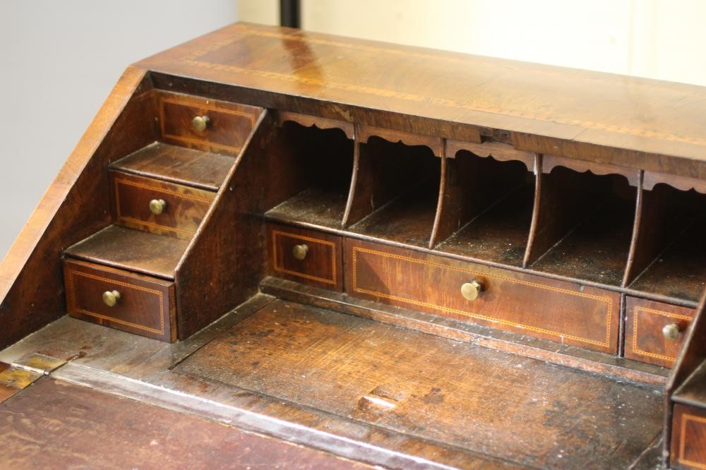 AN EARLY GEORGIAN WALNUT BUREAU Image