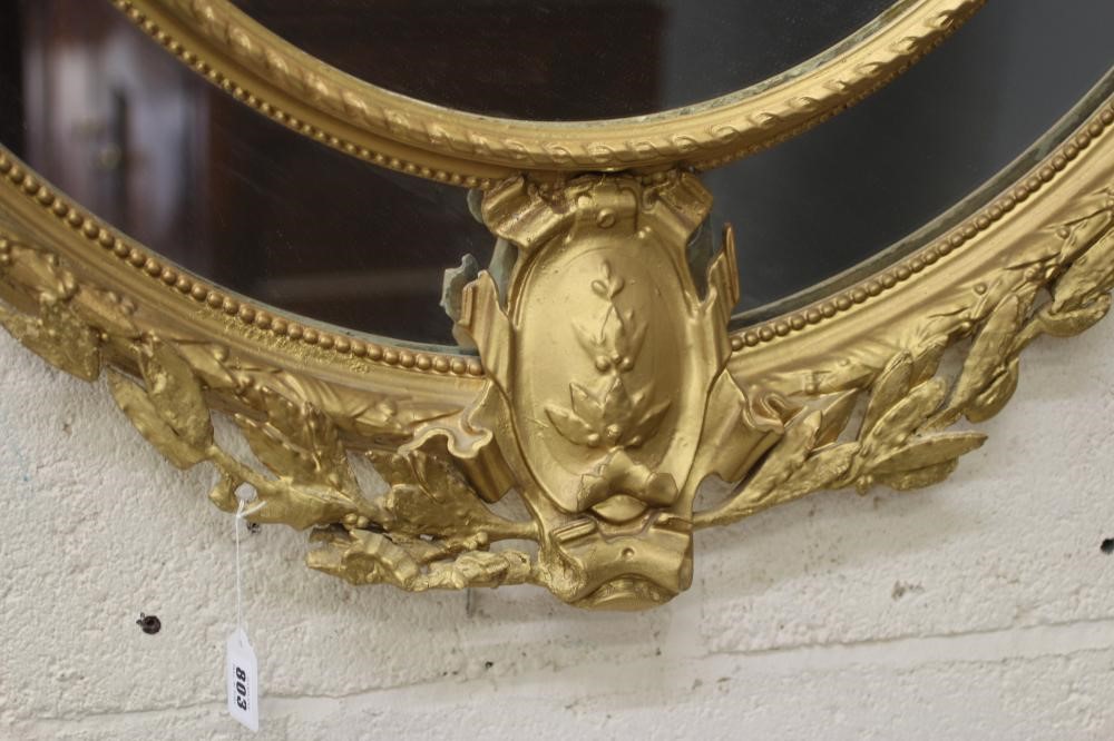 A GILT WOOD OVAL PIER GLASS Image