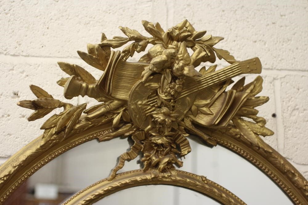 A GILT WOOD OVAL PIER GLASS Image