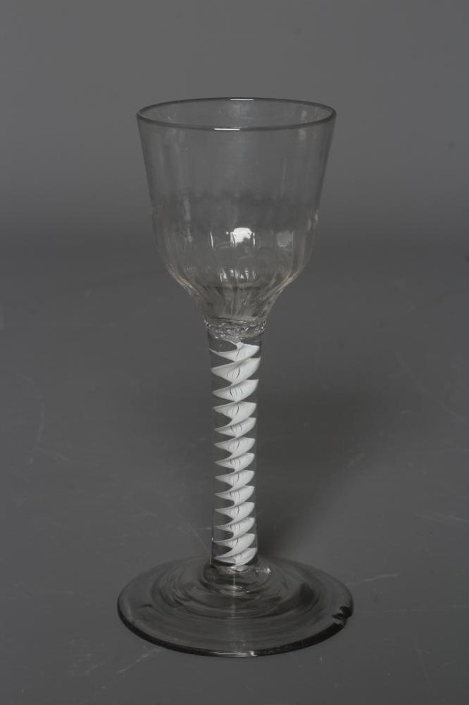 A CORDIAL GLASS, mid 18th century, the ogee bowl with moulded fluting issuing from an opaque white Image