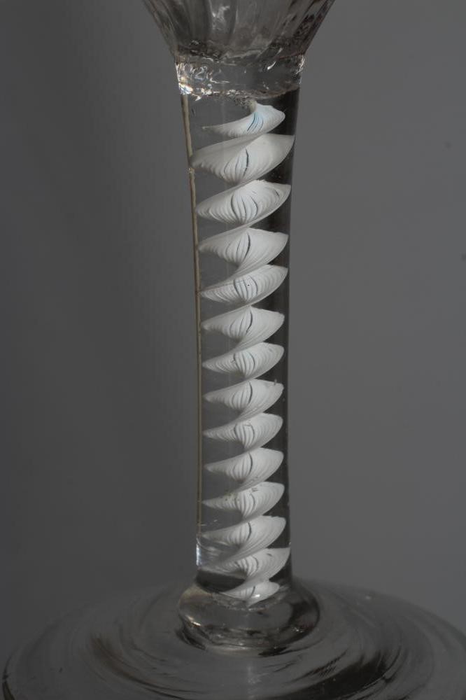 A CORDIAL GLASS, mid 18th century, the ogee bowl with moulded fluting issuing from an opaque white Image