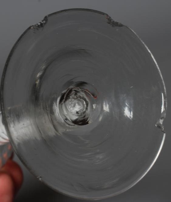 A CORDIAL GLASS, mid 18th century, the ogee bowl with moulded fluting issuing from an opaque white Image