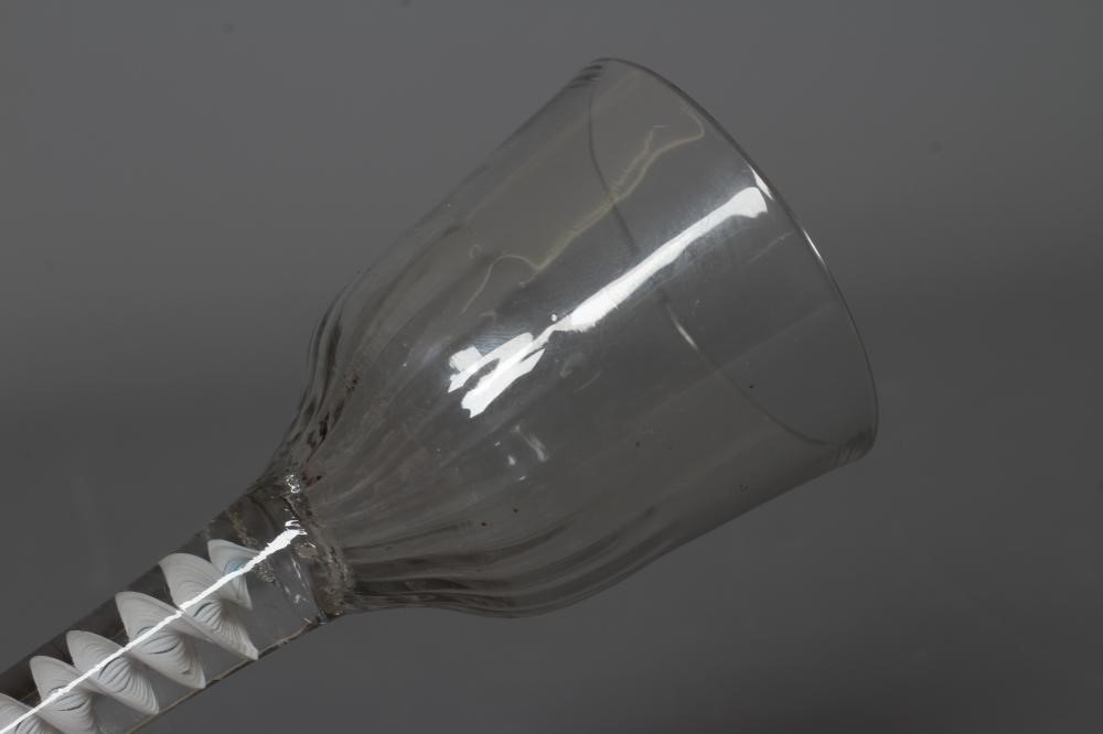A CORDIAL GLASS, mid 18th century, the ogee bowl with moulded fluting issuing from an opaque white Image