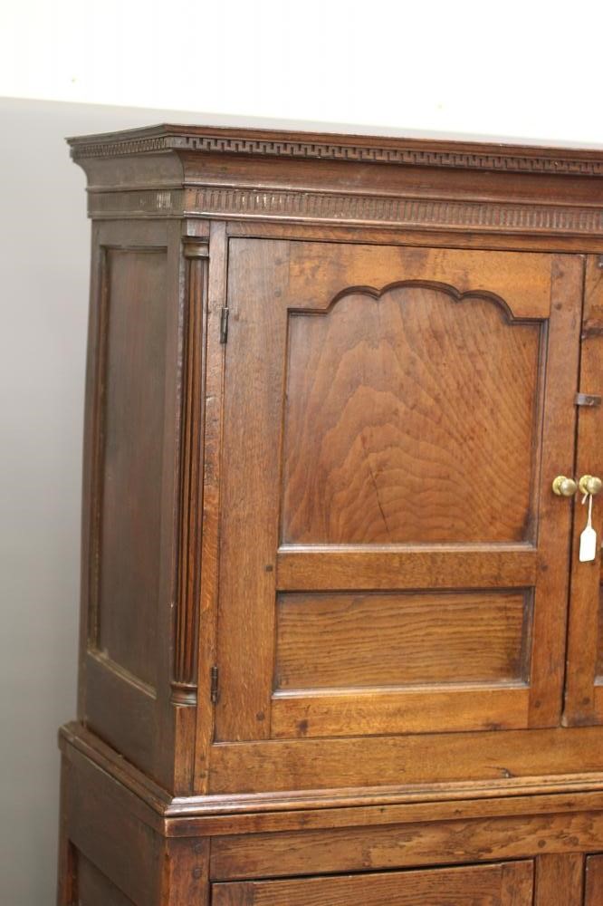 A GEORGIAN OAK PRESS CUPBOARD Image
