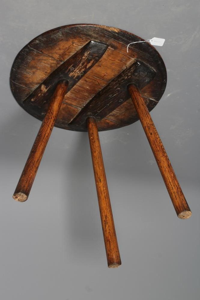 AN OAK CRICKET TABLE, 19th century, the three plank circular top with chamfered lower edge, raised Image