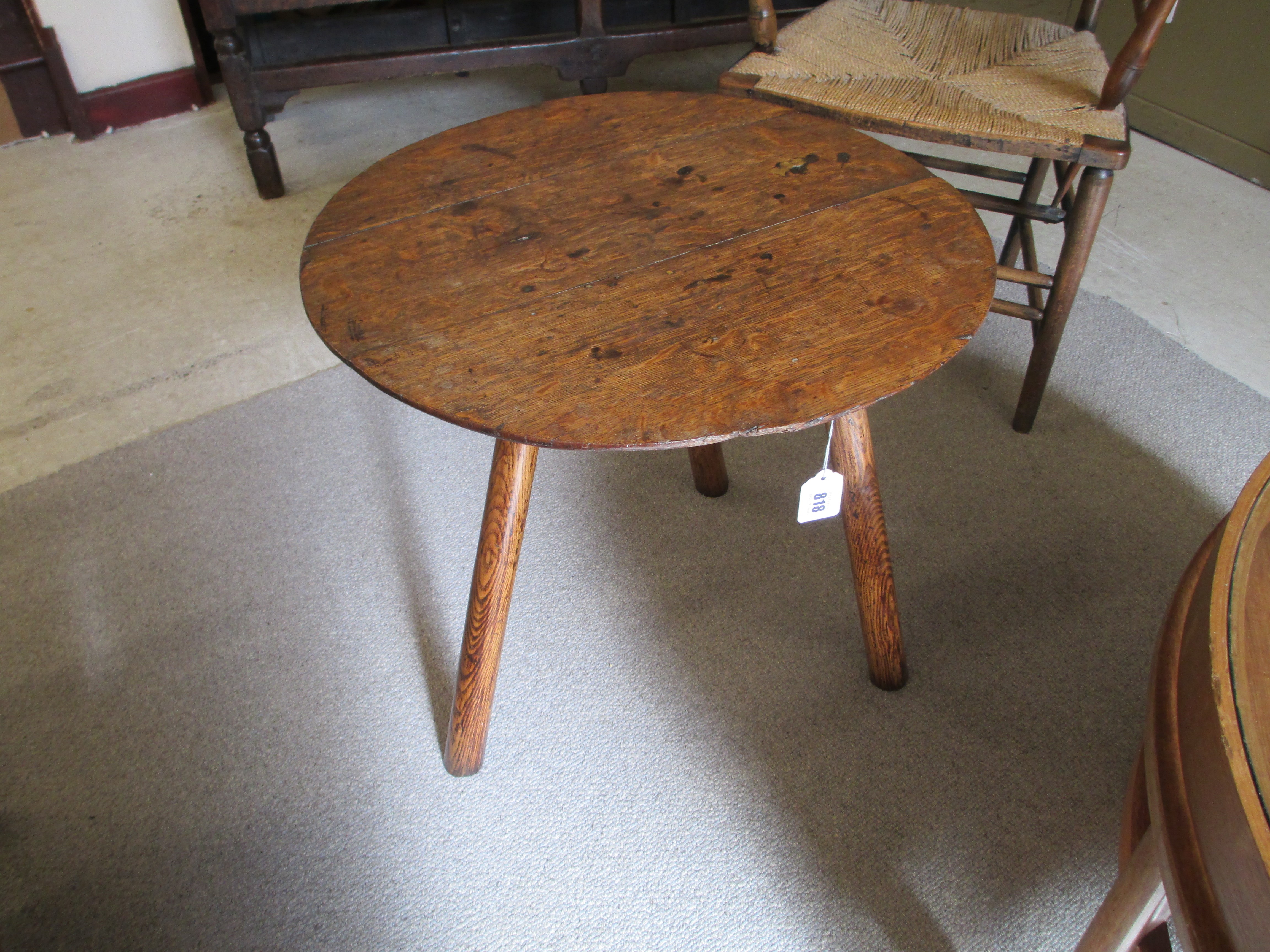 AN OAK CRICKET TABLE, 19th century, the three plank circular top with chamfered lower edge, raised Image