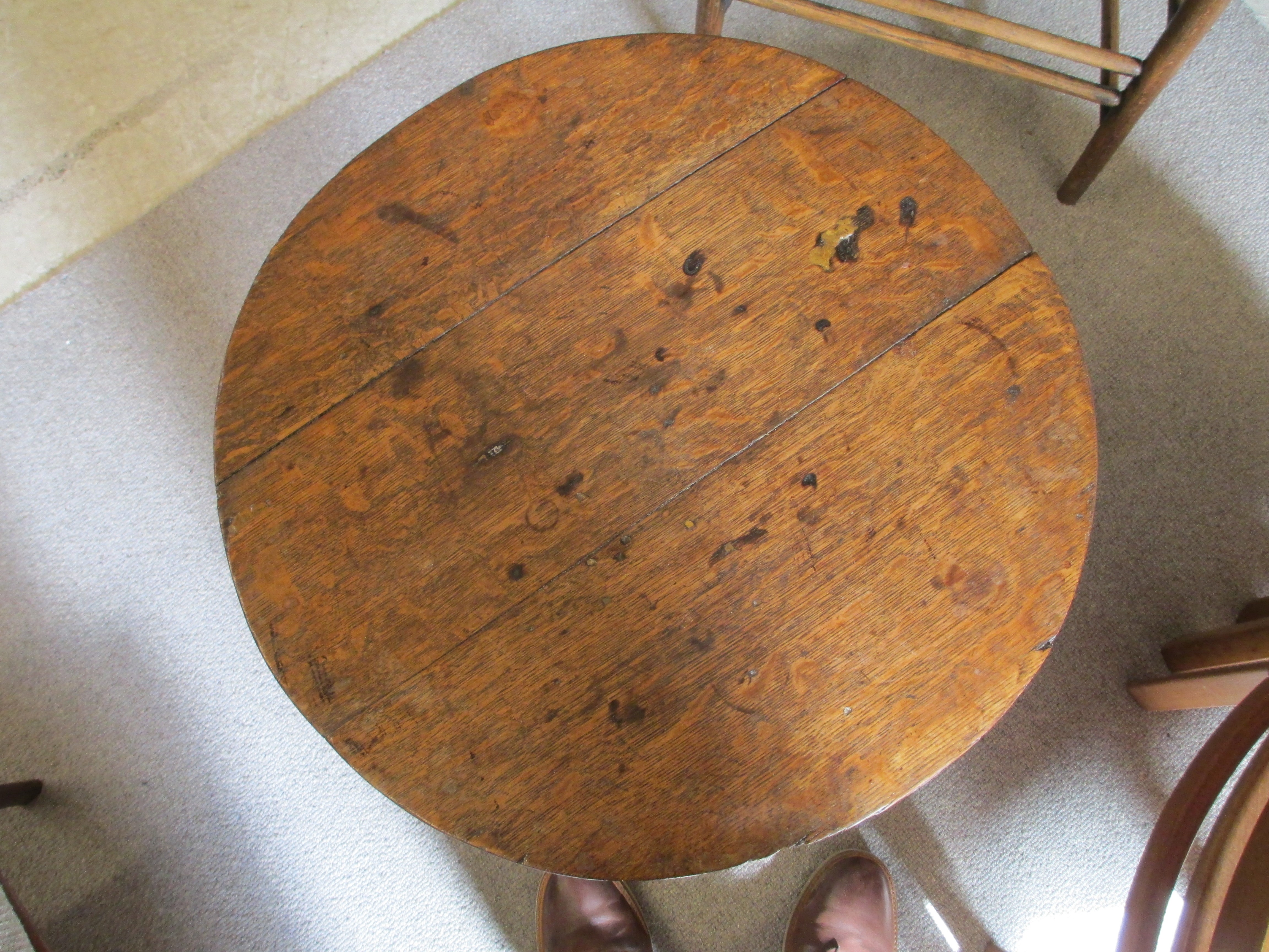 AN OAK CRICKET TABLE, 19th century, the three plank circular top with chamfered lower edge, raised Image