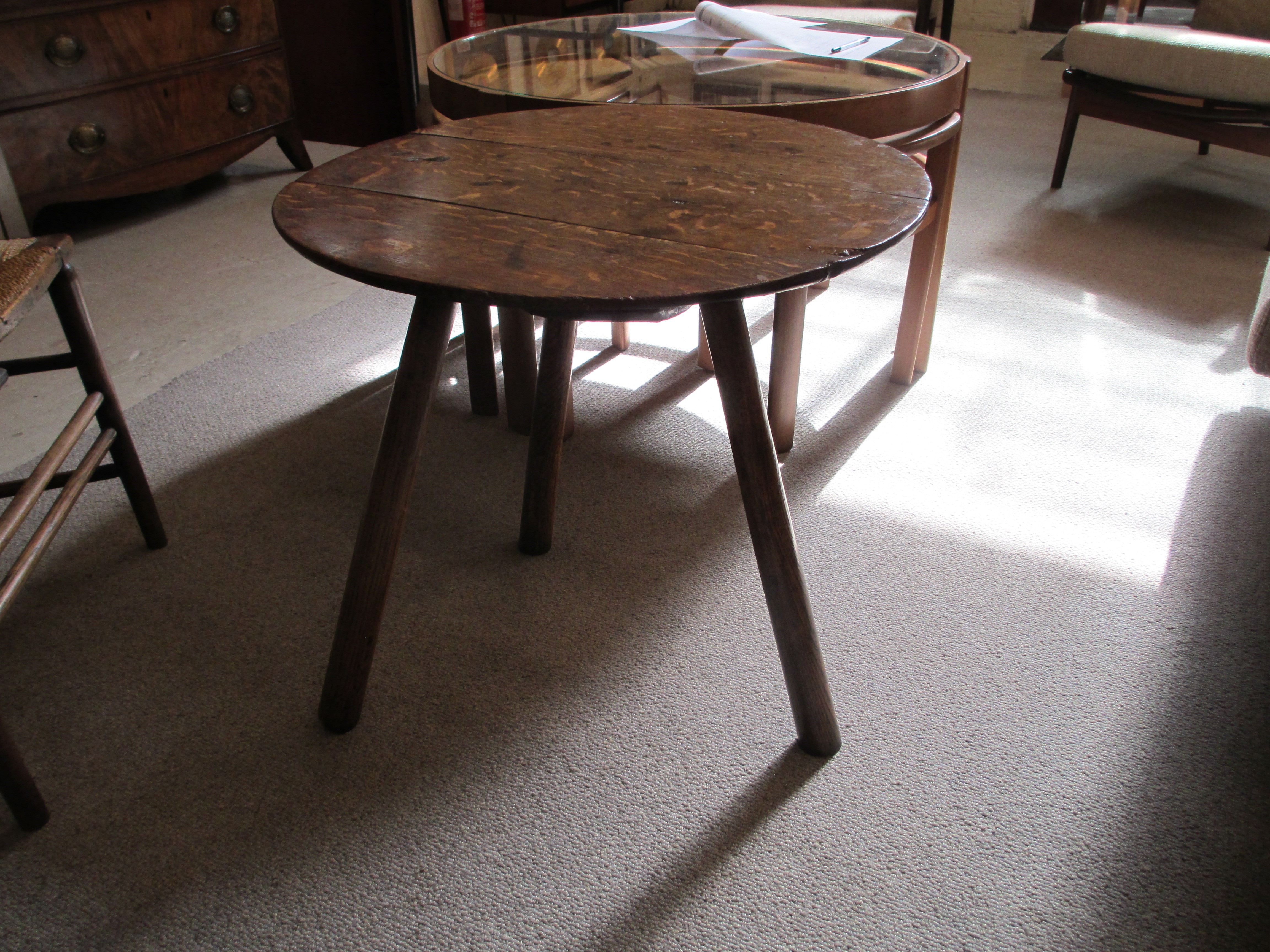 AN OAK CRICKET TABLE, 19th century, the three plank circular top with chamfered lower edge, raised Image