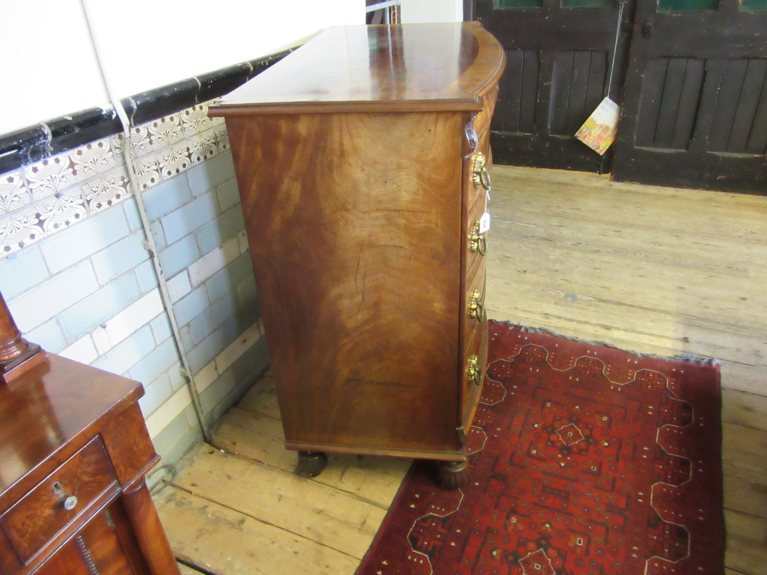 A REGENCY FIGURED MAHOGANY BOW FRONT CHEST Image