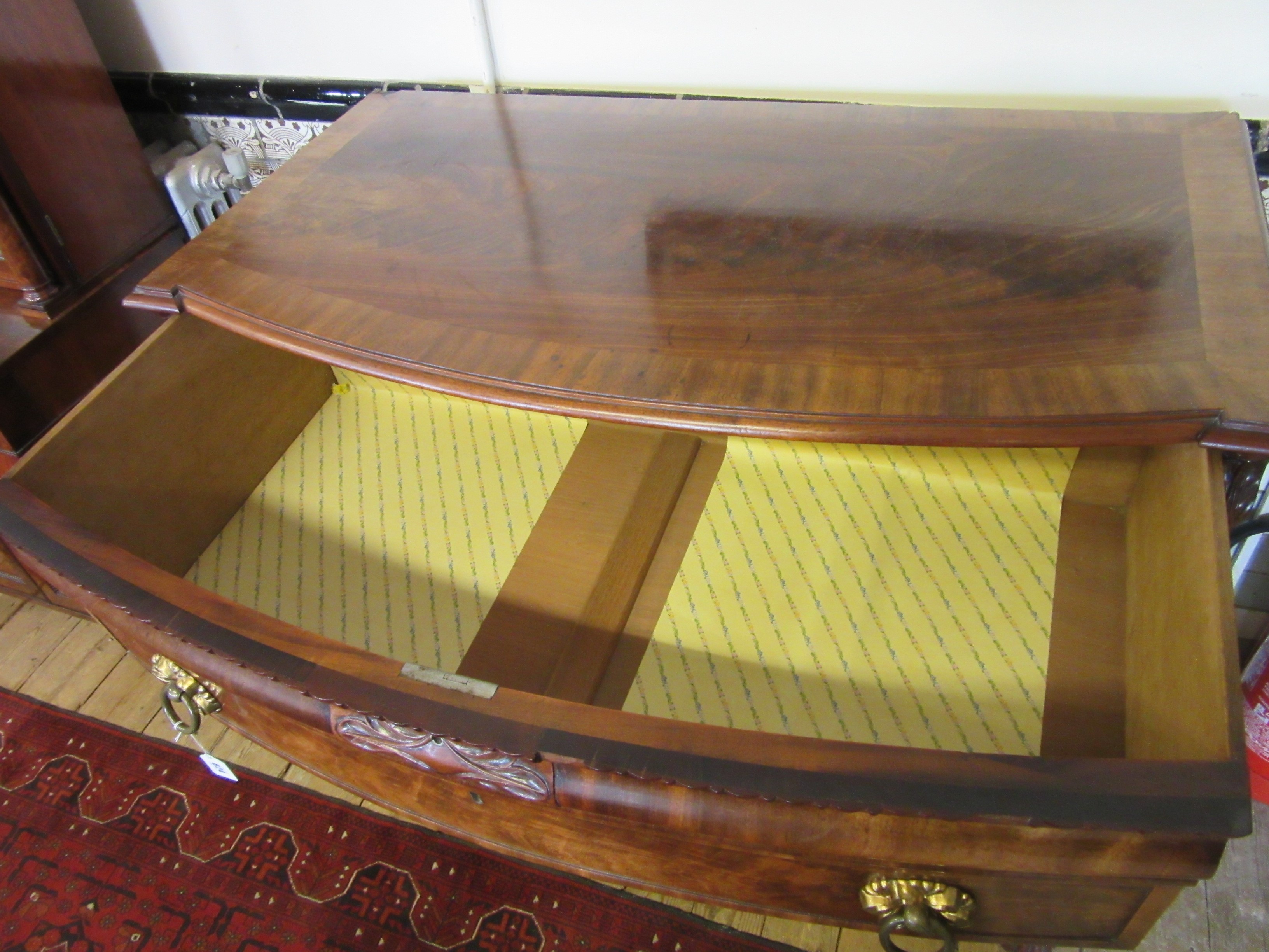 A REGENCY FIGURED MAHOGANY BOW FRONT CHEST Image