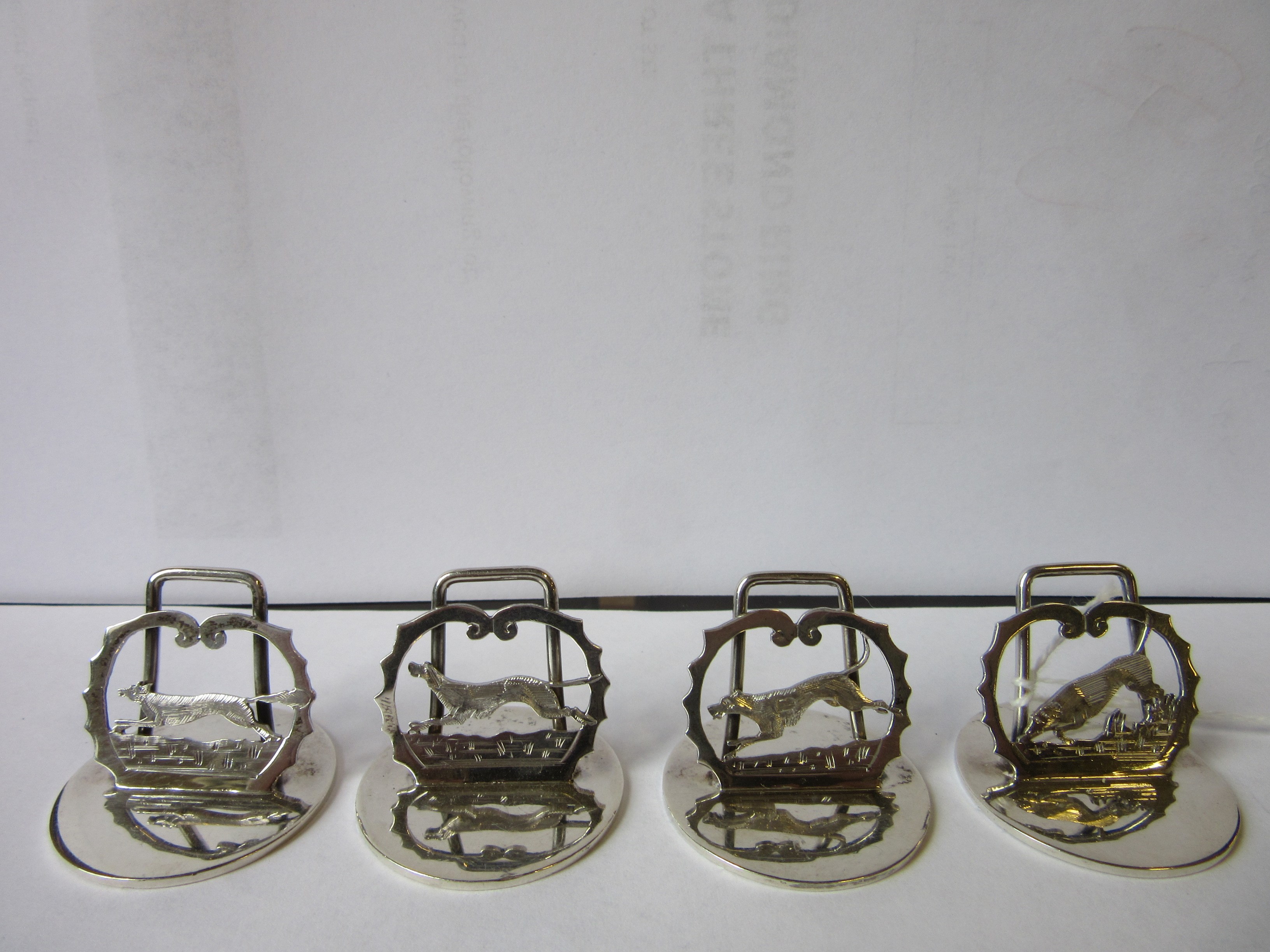 A COMPOSITE SET OF EIGHT NOVELTY MENU/PLACE CARD HOLDERS Image