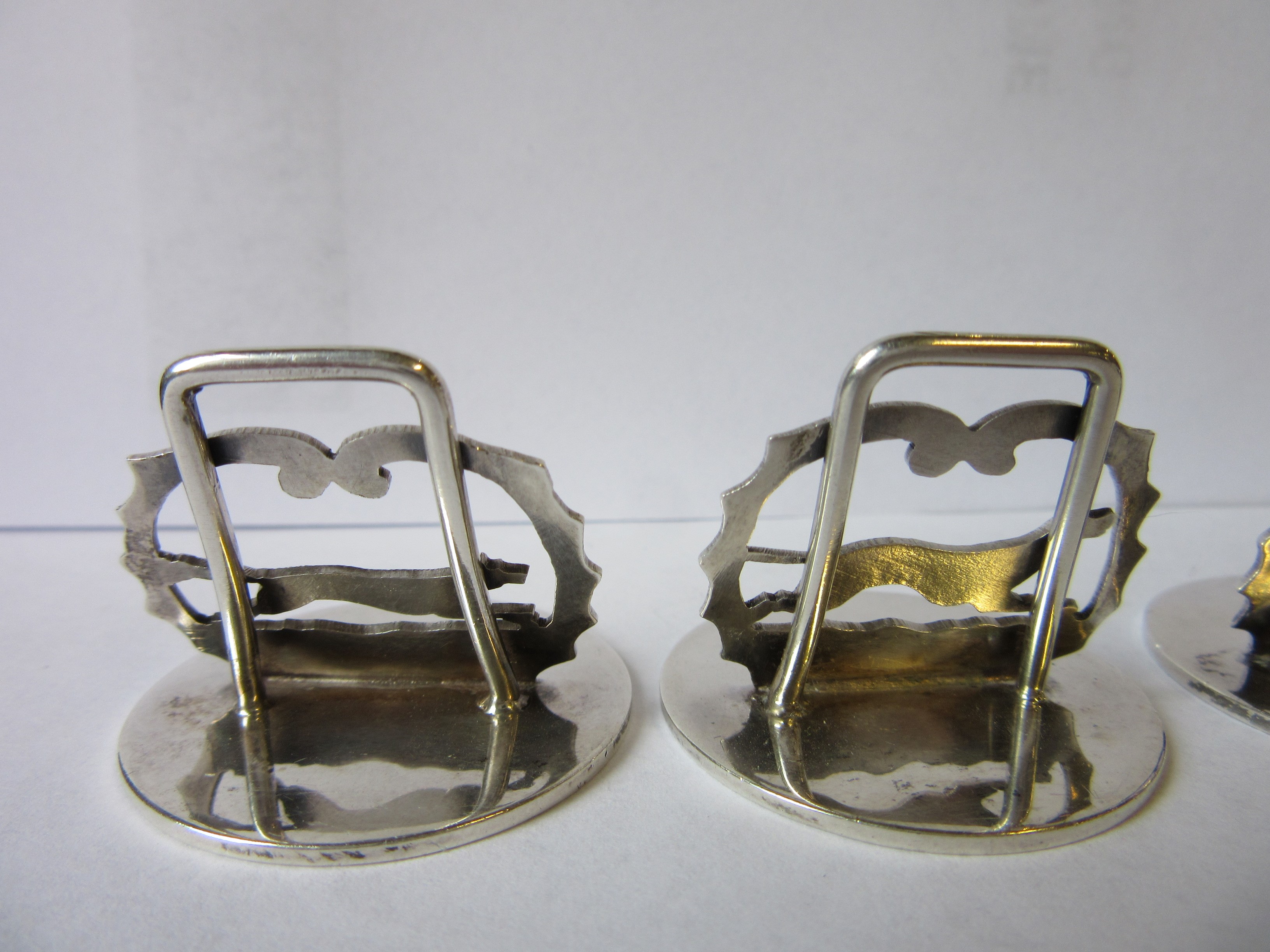 A COMPOSITE SET OF EIGHT NOVELTY MENU/PLACE CARD HOLDERS Image