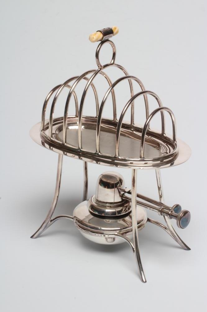A SILVER TOAST-RACK ON STAND WITH BURNER Image