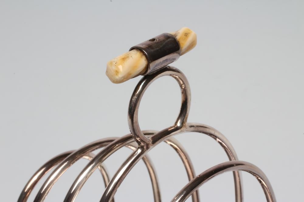 A SILVER TOAST-RACK ON STAND WITH BURNER Image