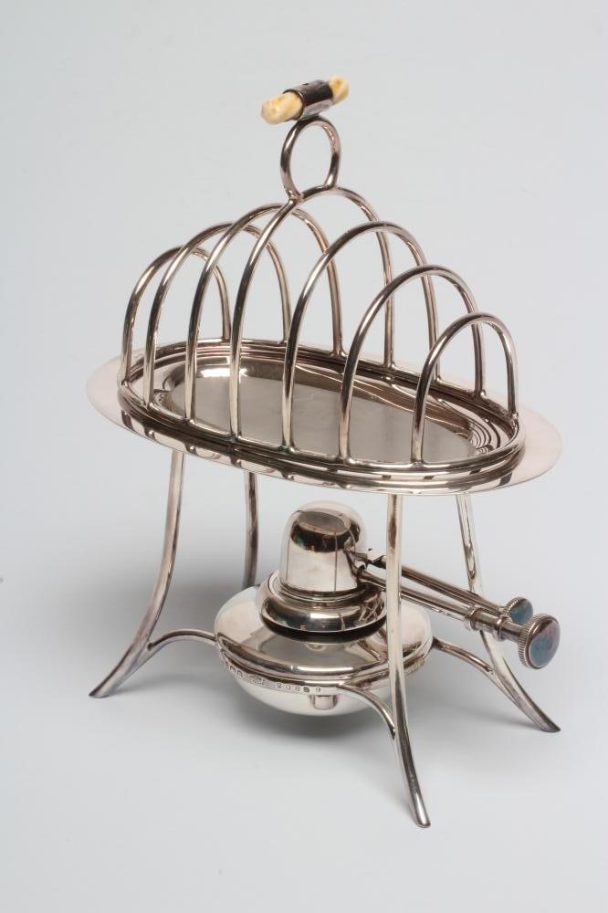 A SILVER TOAST-RACK ON STAND WITH BURNER Image