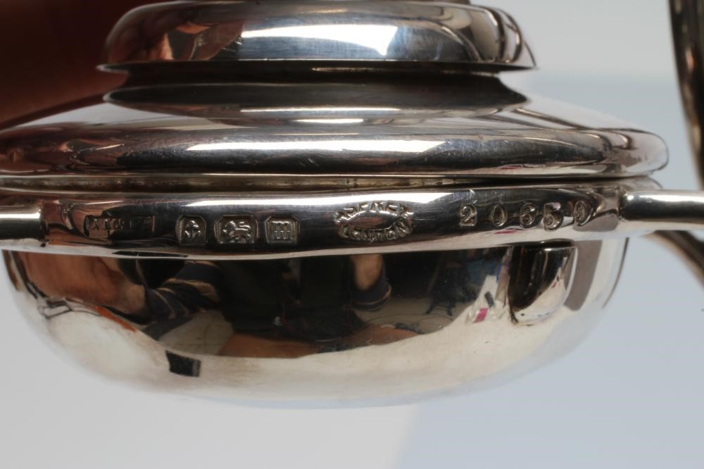 A SILVER TOAST-RACK ON STAND WITH BURNER Image