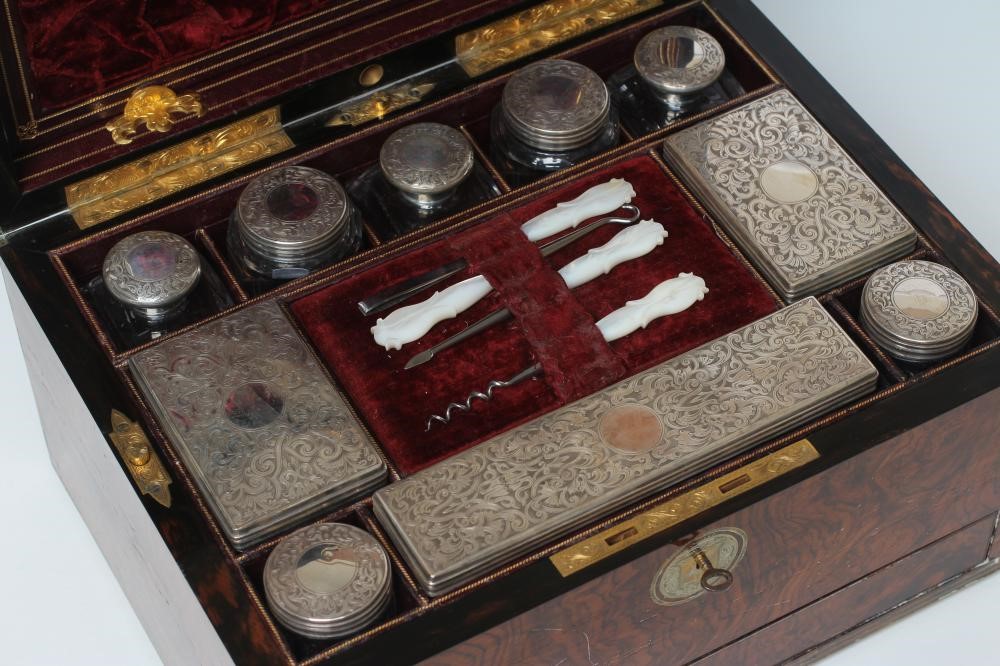 A MID VICTORIAN BURR WALNUT TRAVELLING DRESSING CASE WITH SILVER FITTINGS by Parkins & Gotto Image