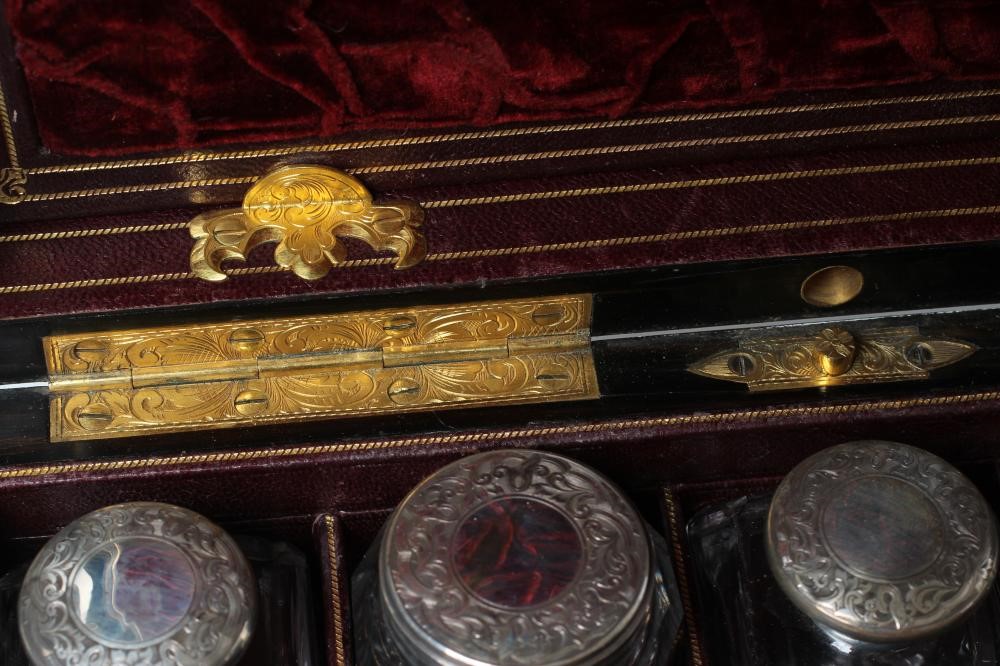 A MID VICTORIAN BURR WALNUT TRAVELLING DRESSING CASE WITH SILVER FITTINGS by Parkins & Gotto Image
