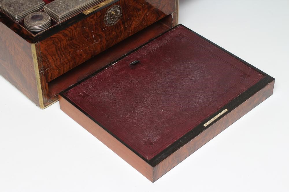 A MID VICTORIAN BURR WALNUT TRAVELLING DRESSING CASE WITH SILVER FITTINGS by Parkins & Gotto Image