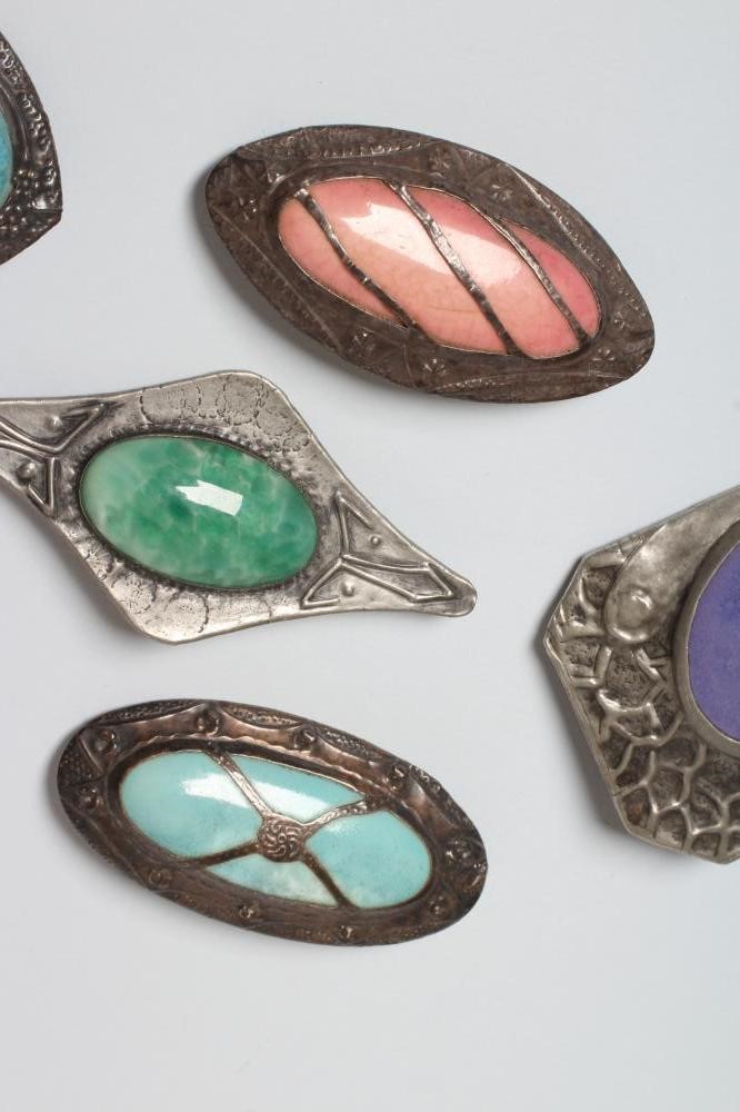 A COLLECTION OF SEVEN RUSKIN TYPE ARTS AND CRAFTS PEWTER BROOCHES Image