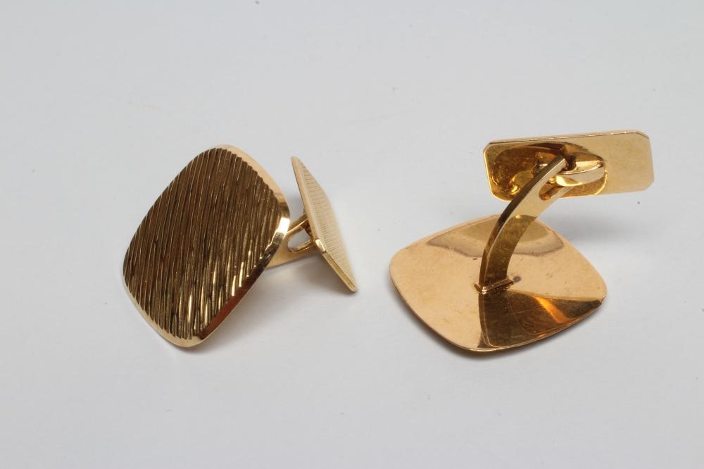 A PAIR OF MODERN CUFFLINKS of rounded square section with brushed bark effect finish and engine Image