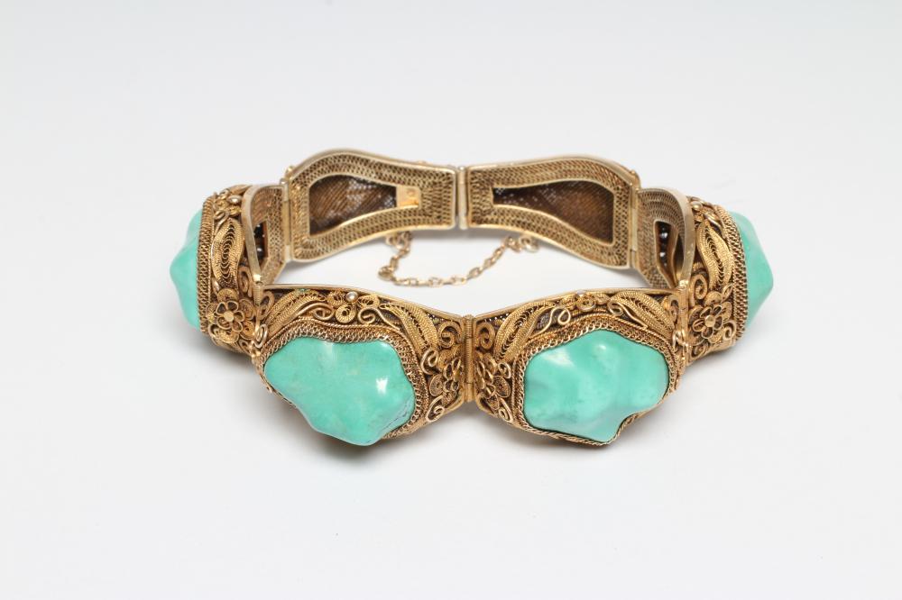 A CHINESE FILIGREE GILT BRACELET inset with four irregular polished green hardstones in cushion Image