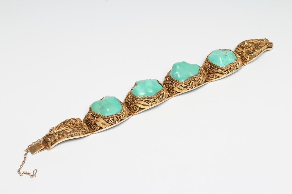 A CHINESE FILIGREE GILT BRACELET inset with four irregular polished green hardstones in cushion Image