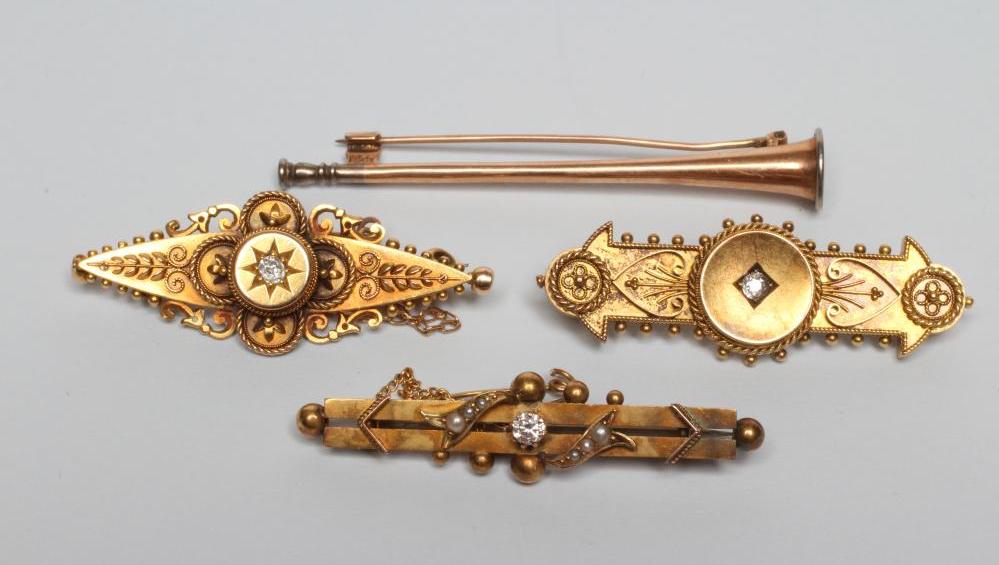 A LATE VICTORIAN 15CT GOLD BROOCH of eliptical form centred by a gypsy set diamond within filigree Image