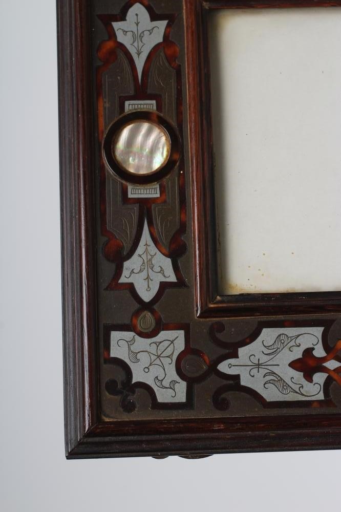 A PAIR OF ENGLISH EDWARDIAN CONTRA-PARTIE BOULLE PHOTOGRAPH FRAMES of plain strut back oblong form Image