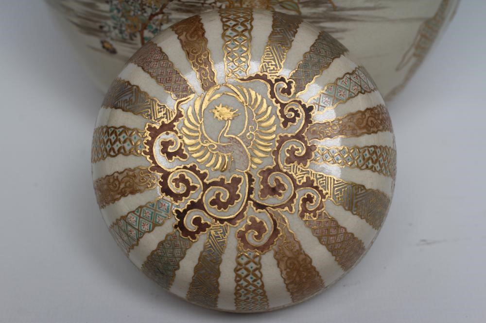 A SATSUMA EARTHENWARE JAR AND COVERS painted in pale palette with two vignettes of three children Image