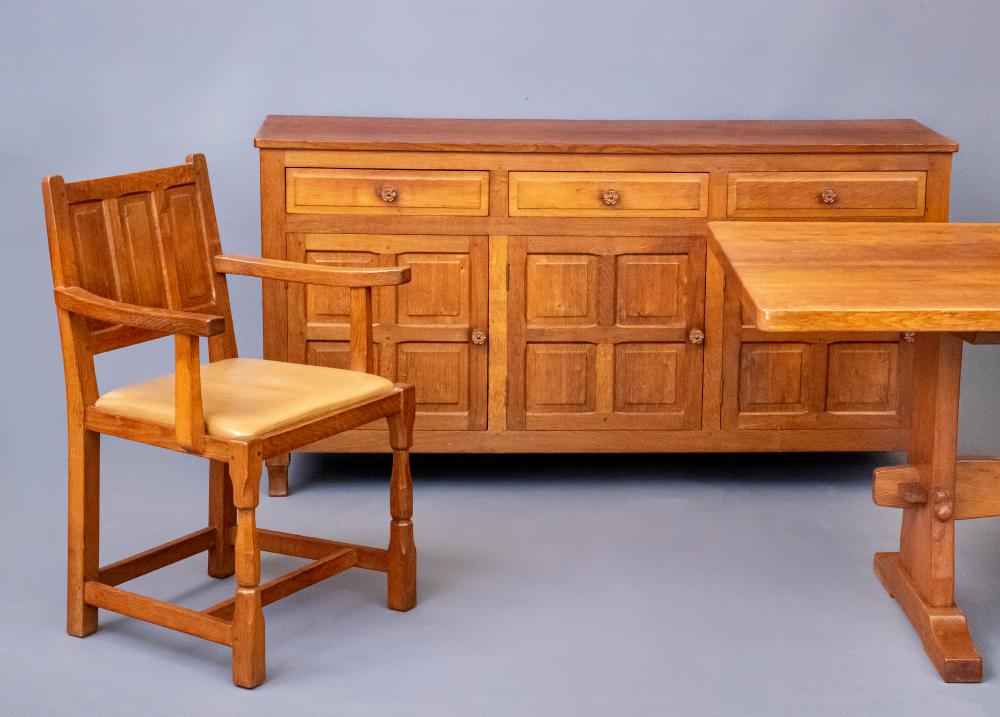 A COLIN ALMACK ADZED OAK DINING SUITE comprising multi panelled sideboard Image
