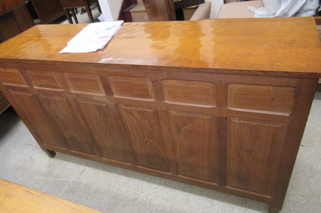 A COLIN ALMACK ADZED OAK DINING SUITE comprising multi panelled sideboard Image