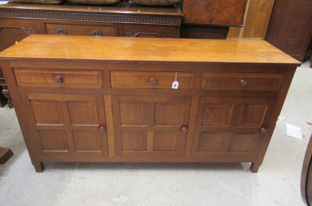 A COLIN ALMACK ADZED OAK DINING SUITE comprising multi panelled sideboard Image