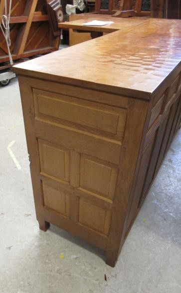 A COLIN ALMACK ADZED OAK DINING SUITE comprising multi panelled sideboard Image