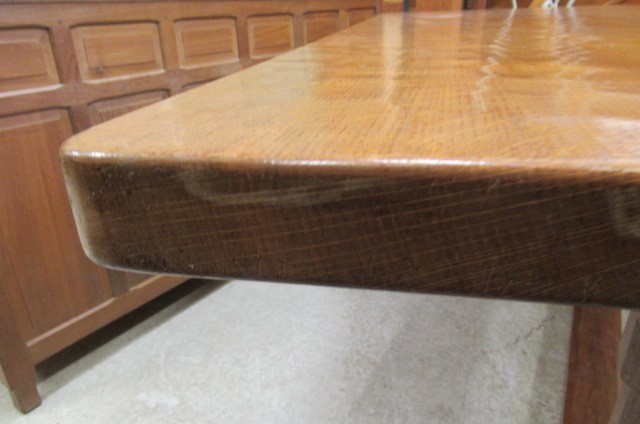 A COLIN ALMACK ADZED OAK DINING SUITE comprising multi panelled sideboard Image